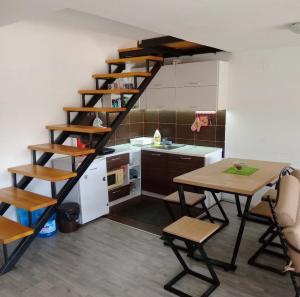 a kitchen with a spiral staircase in a room at Bovan vikendica za izdavanje in Jezero