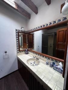 a bathroom with a sink and a mirror at Rustic Escape Between Valle & Avándaro in Valle de Bravo +14 photos