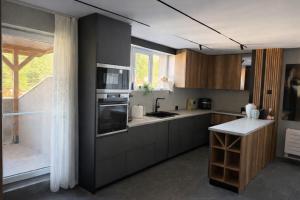 a kitchen with a sink and a stove top oven at Forest Panorama Luxury Apartment in Velingrad