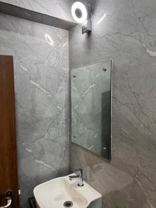 a bathroom with a sink and a mirror at HOTEL SREE DURGA in Kolkata