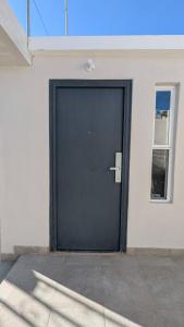 a black door on the side of a building at Acogedora Casa in El Sauzal +2 photos