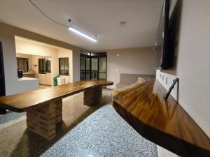 a living room with a wooden table in a room at La Villa de Sofia in Santa Marta
