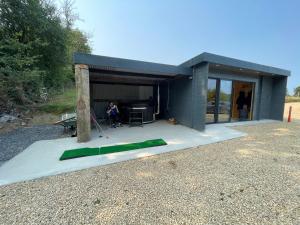 a woman is sitting in a shed with a green tent at Executive Cabin and Jacuzzi 2 in Monaughrun Cross Roads