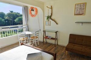 a bedroom with a bed and a balcony at Vacances au port in Saint-Cyprien-Plage