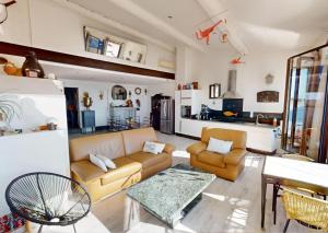 a living room with a couch and a table at Sunset lodge in Bouzigues