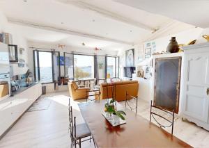 a kitchen and living room with a table and chairs at Sunset lodge in Bouzigues +7 photos
