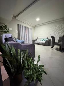 a living room with a couch and a bed at Triplex Aconchego in Itapoa +32 photos