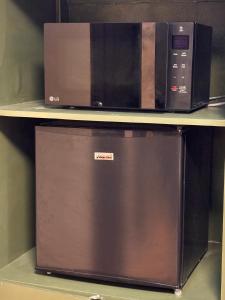 two microwaves sitting on top of a shelf at Casa Selenó in Batangas City