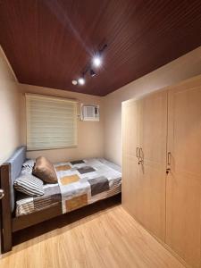 a small bedroom with a bed and a closet at Casa Selenó in Batangas City