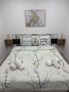 a bedroom with a large bed with two pillows at Appart' Cosy proche Mulhouse in Illzach