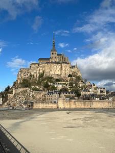 a large building on top of a mountain at Les Moussaillons, plage à pieds in Jullouville-les-Pins