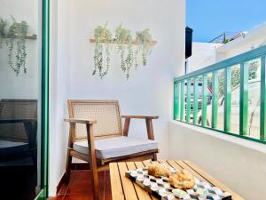 a balcony with a chair and a table at Canaryislandshost l Bruma in Famara