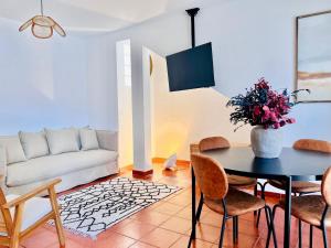 a living room with a table and a couch at Canaryislandshost l Bruma in Famara