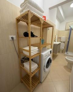 a bathroom with a washer and a washing machine at Cordi Casa Vacanze in Giulianova +21 photos