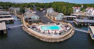 an aerial view of a resort with a pool in the water at The Little Penthouse in Lake Ozark