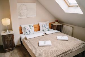 a bedroom with a bed with two towels on it at Willa tuŻur in Osie +61 photos