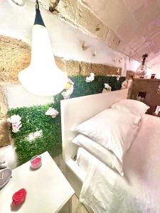 a bedroom with a bed and flowers on the wall at Il Cuore di San Cipriano in Mesagne
