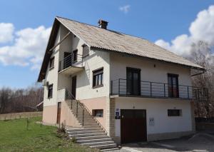an old house with a staircase on the side of it at MonteMare Holiday home in Lič