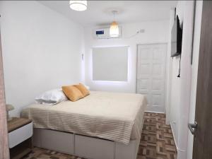 a bedroom with a bed with white sheets and a window at Cesar - Caesars in La Rioja