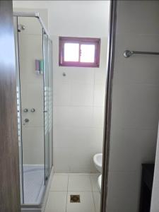 a bathroom with a shower and a toilet and a window at Cesar - Caesars in La Rioja
