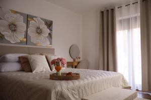 a bedroom with a bed with a tray with flowers on it at MonteMare Holiday home in Lič
