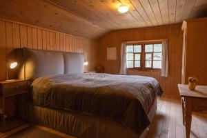 a bedroom with a large bed in a wooden room at  
