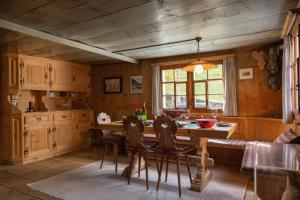 a kitchen with a table and chairs in a room at  