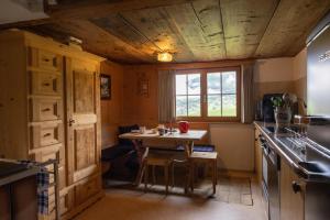 a small kitchen with a table and a window at   +14 photos