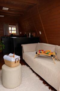 a living room with two couches and a table at Cabanas Farol in Pântano Grande +17 photos