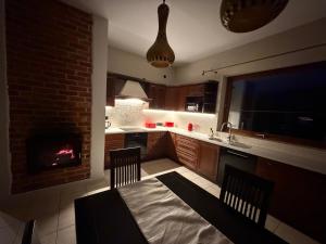 a kitchen with a dining table and a fireplace at Klakierówka in Piechowice