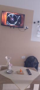 a tv hanging on a wall above a table at San Jose Termas in Federación