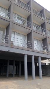 an apartment building with columns in front of it at San Jose Termas in Federación