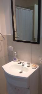 a bathroom with a white sink and a mirror at San Jose Termas in Federación +4 photos