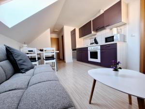 a living room with a couch and a table at Špirala place - near city center, free parking in Bled