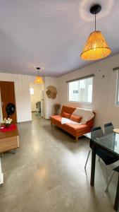 a living room with a couch and a table at Casas Carole Maramar Beach House 35 e 36 in Luis Correia