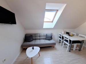 a living room with a couch and a table at Špirala place - near city center, free parking in Bled