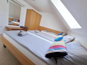 a bed with two pillows on it in a room at Špirala place - near city center, free parking in Bled