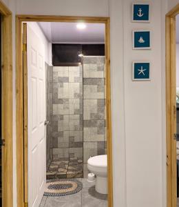 a bathroom with a toilet and a walk in shower at Marea Azul Guanacaste in Puerto Soley +18 photos