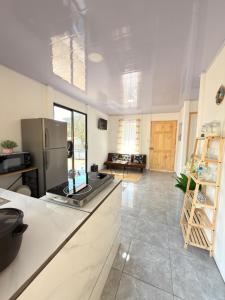 a kitchen with a refrigerator and a counter top at Marea Azul Guanacaste in Puerto Soley