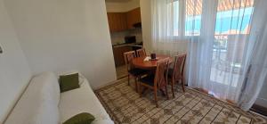 a small room with a table and chairs and a kitchen at Apartments Buljan in Kožino