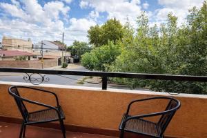 two chairs sitting on a balcony looking out at a street at Ana Rent II Departamento Moderno ,equipado en San Isidro cerca de Tigre River y Tecnopolis in Boulogne
