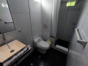 a small bathroom with a toilet and a sink at Hotel Quilla in Urubamba +63 photos
