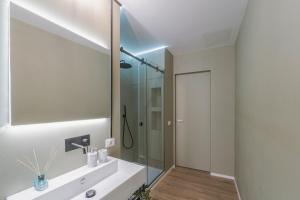 a bathroom with a sink and a mirror at Palazzo Lucatelli Suite - Centro in Trapani +29 photos