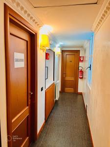 a hallway with two doors and a hallwayngth at Beauty Rooms in Rome