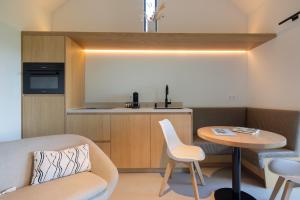 a living room with a couch and a table at Guesthouse 'Elements' with panoramic views in Bergen