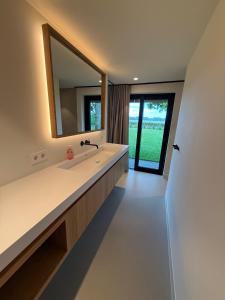 a bathroom with a sink and a mirror at Guesthouse 'Elements' with panoramic views in Bergen +33 photos