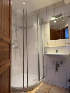 a bathroom with a shower and a sink at Hotel Maien in Todtmoos in Todtmoos