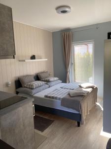 a bedroom with two beds and a window at Bagoly in Fertőrákos +21 photos