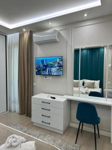 a bedroom with a desk and a bed with a mirror at Glenis Apartment Vollga in Durrës