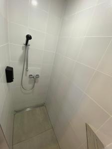 a bathroom with a shower stall with a phone on the wall at Bagoly in Fertőrákos
